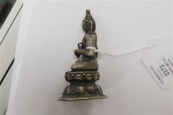 A white metal Buddha